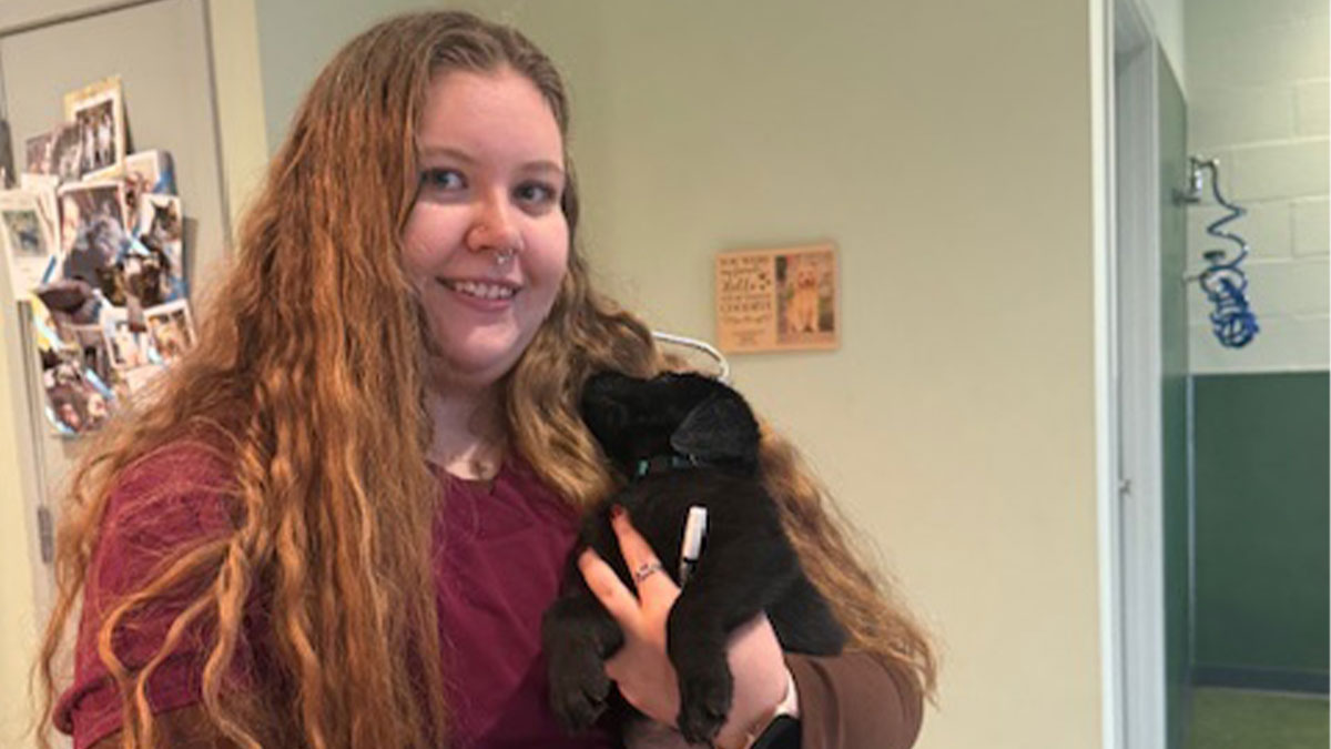 Smiling-veterinarian-with-puppy Smiling veterinarian with puppy.